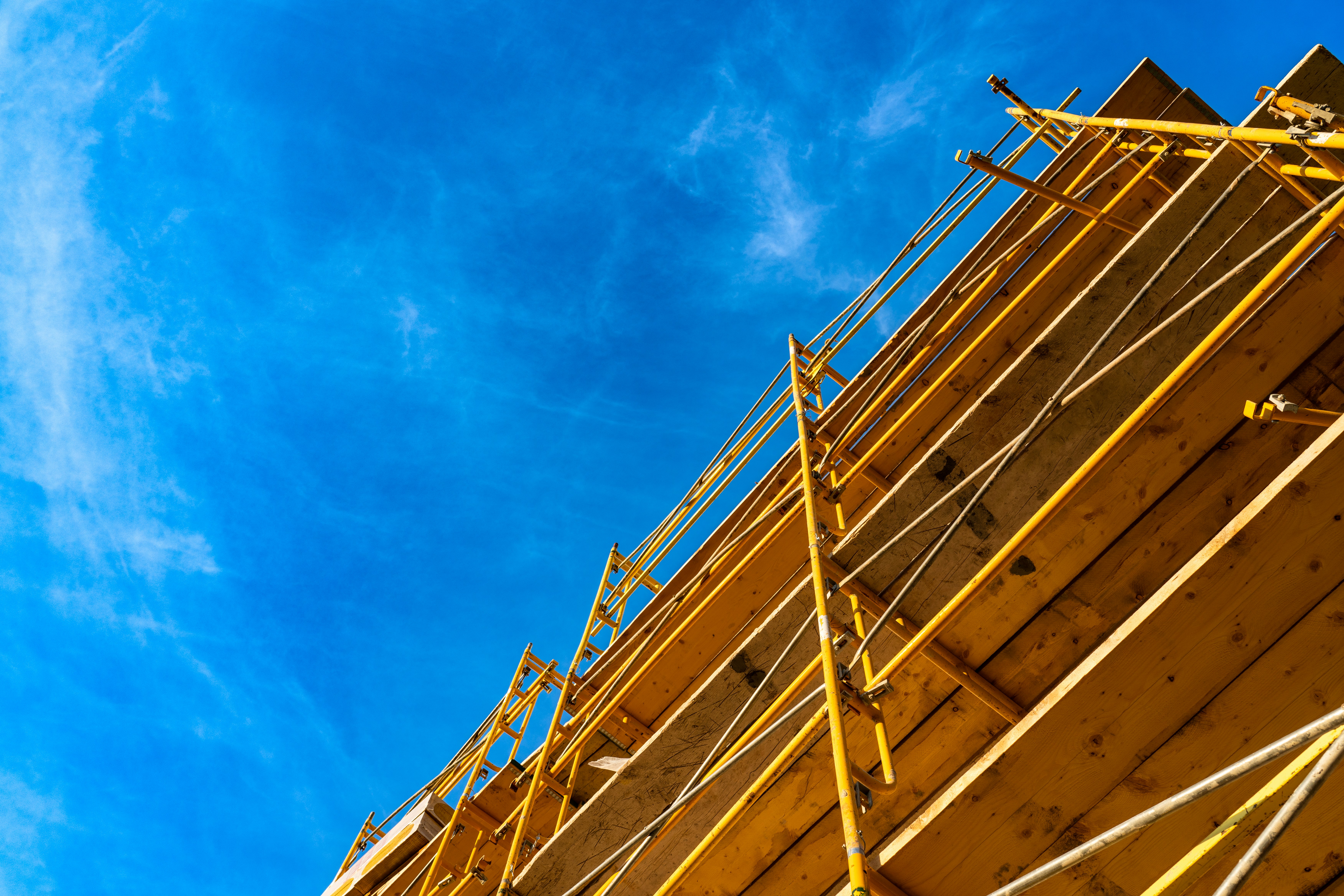 blue skies and colorful construction scaffolding
